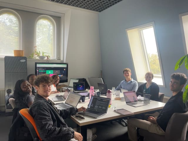 People working together at a table during a hackathon