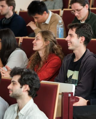 A SAIN lecture filling a university auditorium