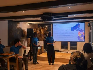 Two participants presenting their final project to the room