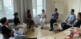 A discussion group seated around a table in Utrecht